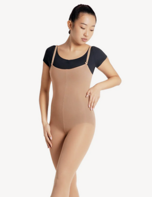 Woman wearing a beige bodysuit with a black top on a white background