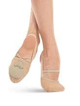 A pair of beige ballet shoes with elastic accents around the forefoot and heel areas.